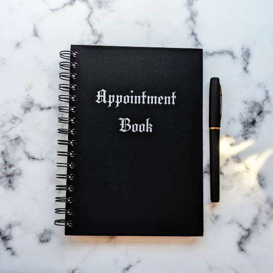 The cover of the Appointment Book by Gothic Office. The cover is black with white gothic font. 