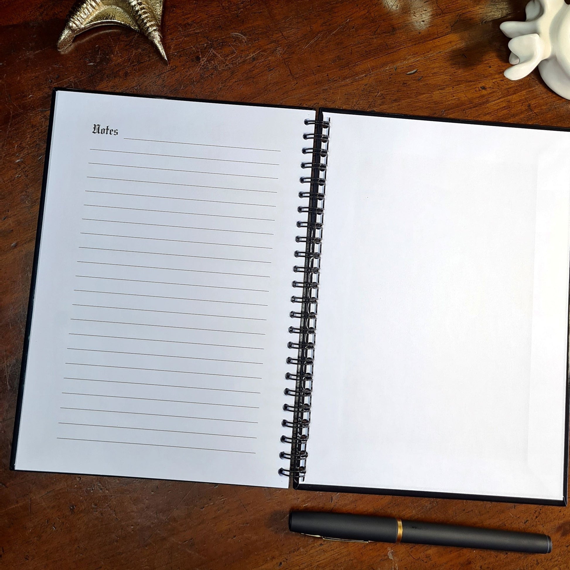 A two page layout inside the Fitness Planner by Gothic Office. The left page is a lined Notes page and the right is a plain white inside of the back cover. 