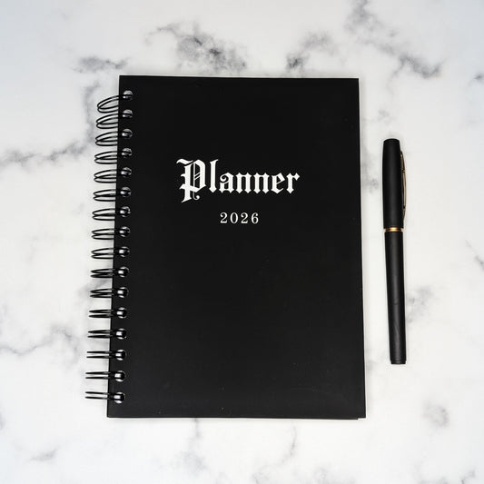The front of the Gothic Office 2026 Planner which is jet black with white gothic font saying the word Planner and 2026. 