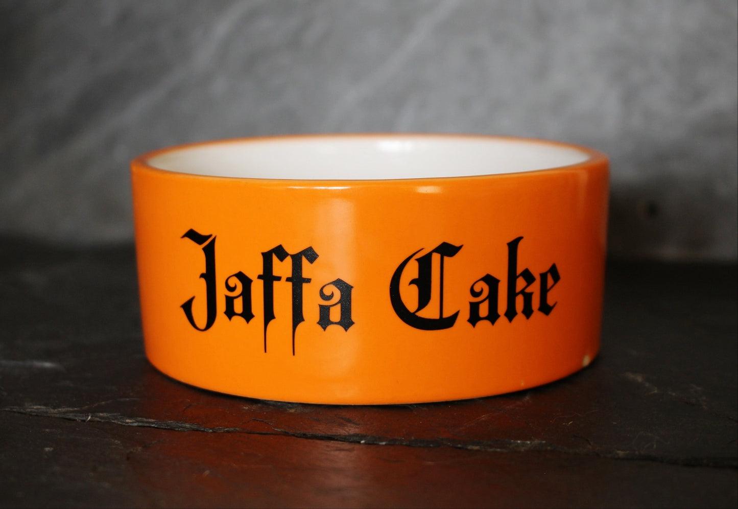 This is an orange pet bowl with the name Jaffa Cake on by Gothic Office.