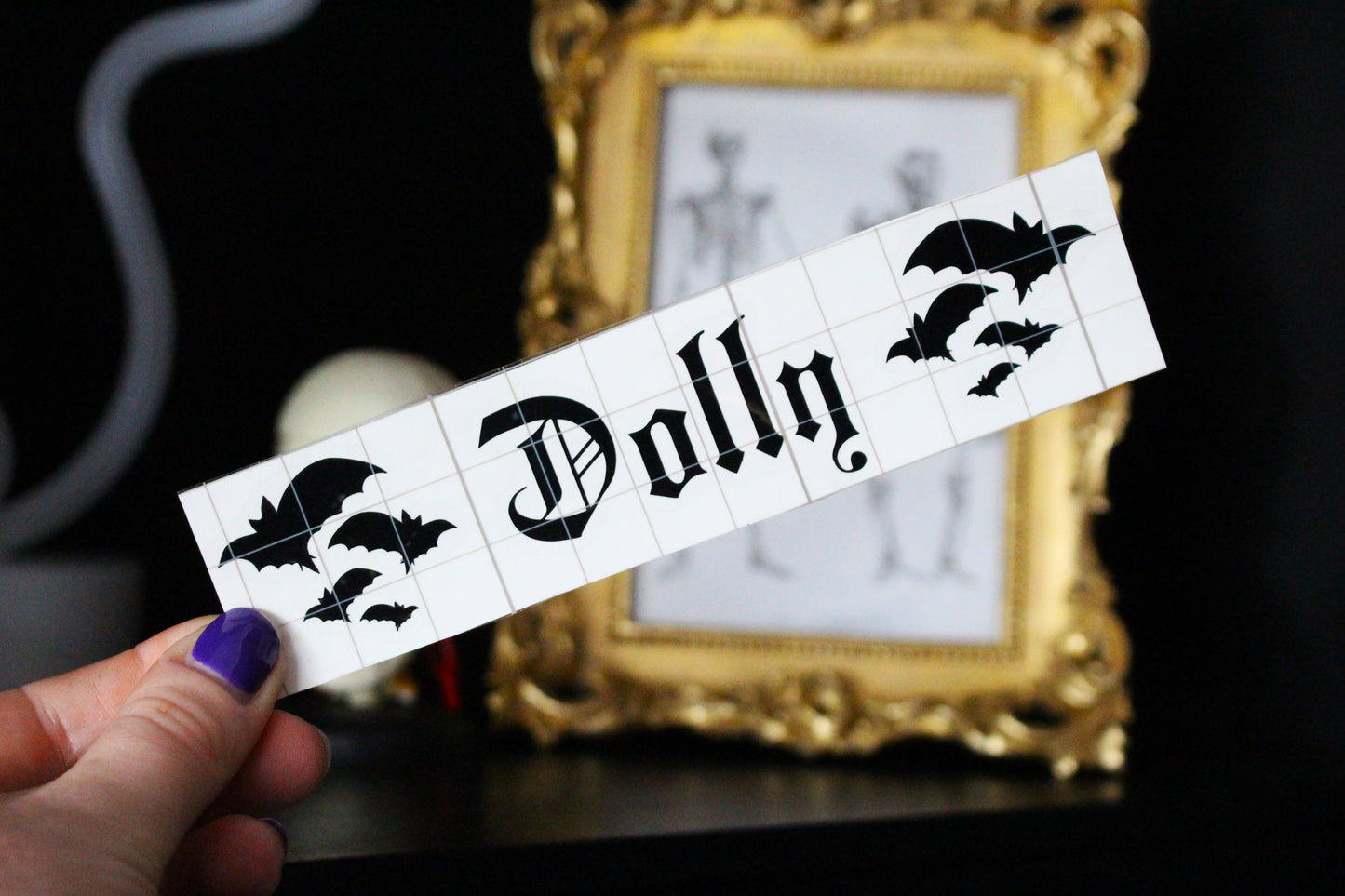 This is a personalised vinly by Gothic Office saying Dolly with bats either side.