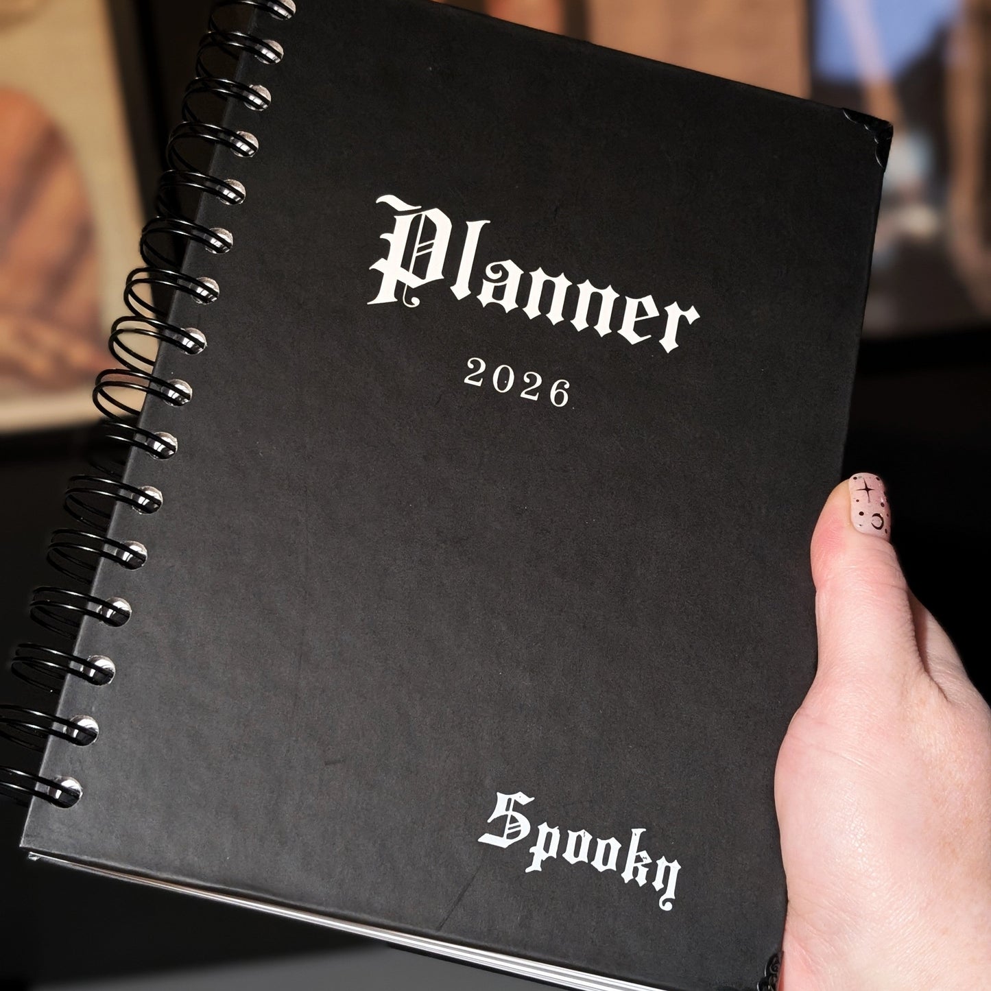 A close up of a Gothic Office planner with white embossing of the word Spooky.
